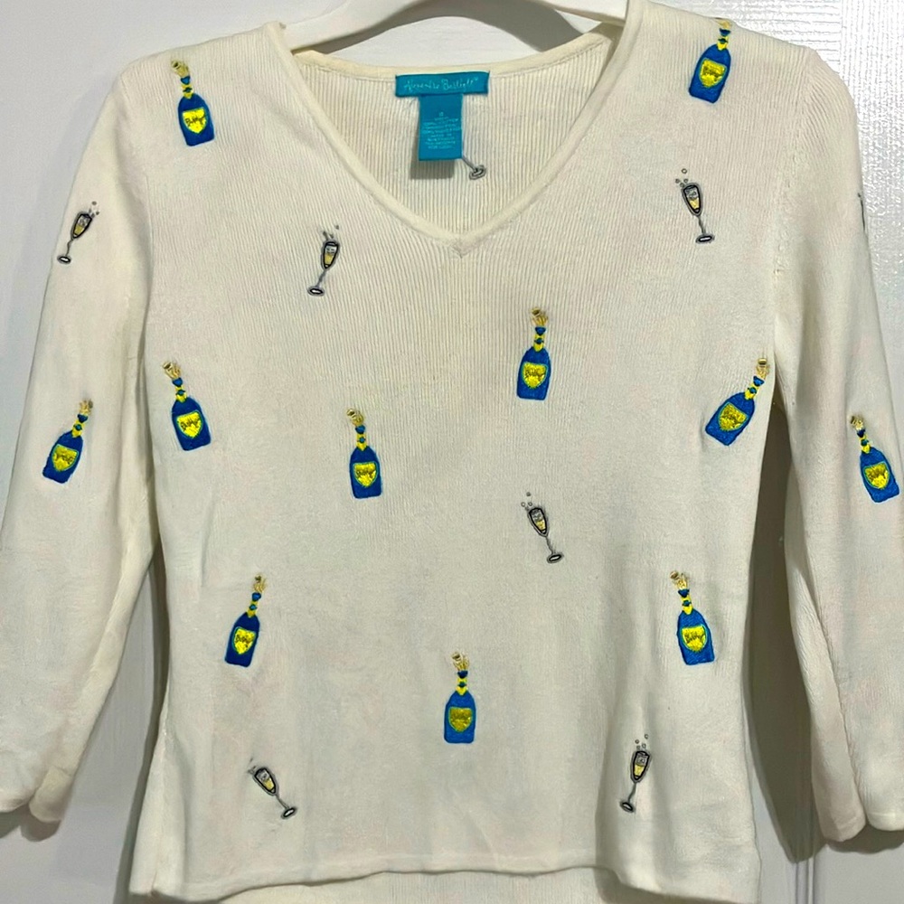 Fun sweater with champagne bottles, and glasses